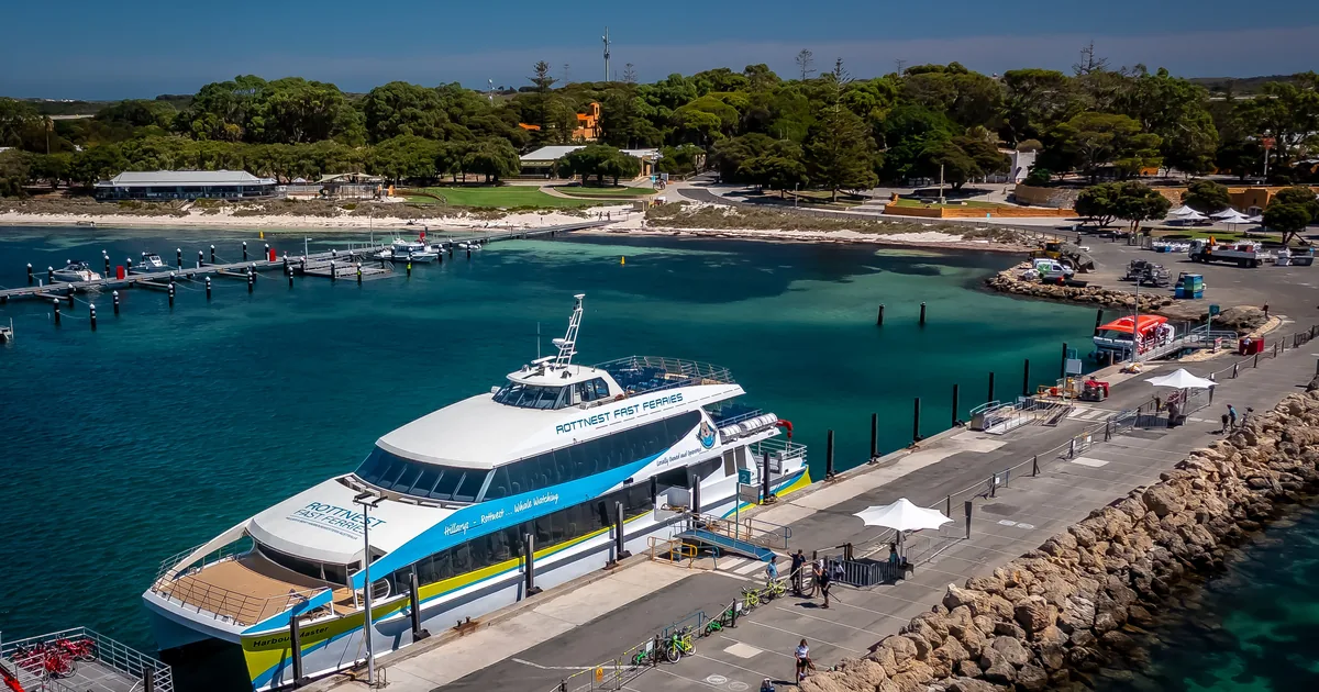 Aerial view of the Rottnest Island ferry jetty in Thomson Bay with a ferry moored and turquoise water